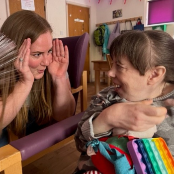 Carer Playing Peekaboo with Female