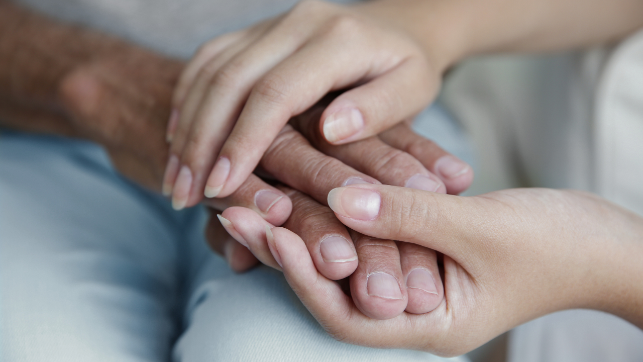 Hands holding eachother supportively