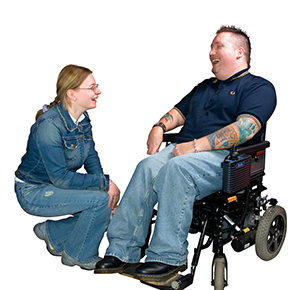 ManWheelchairWithWomanCrouching.jpg